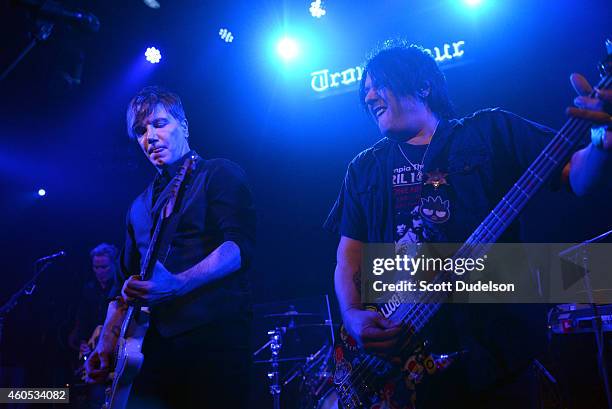 Guitarist / singer John Rzeznik and bass player Robby Takac of The Goo Goo Dolls perform on stage at Troubadour on December 15, 2014 in West...