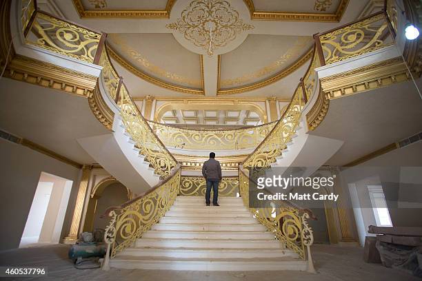 Construction worker walks up the staircase inside the replica White House, a $20million villa being built inside Dream City, a new exclusive...
