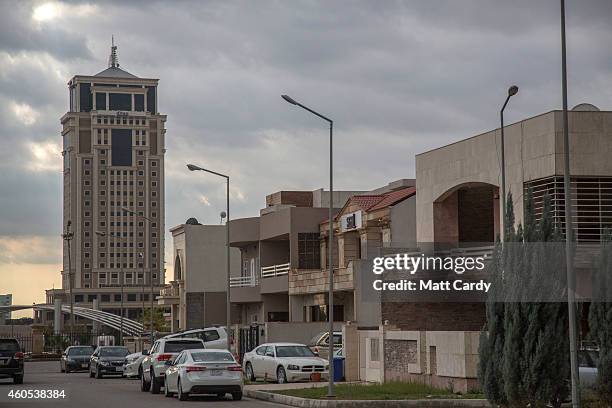 High value cars are parked outside luxury properties inside Dream City, a new exclusive residential suburb that is being developed in Erbil on...