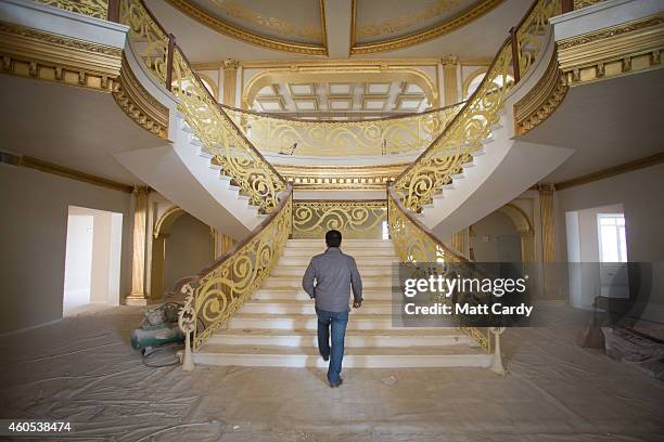 Construction worker walks up the staircase inside the replica White House, a $20million villa being built inside Dream City, a new exclusive...