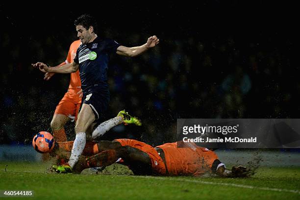 Michael Timlin of Southend is tackled by Danny Shittu of Millwall during the FA Cup Third Round match between Southend United and Millwall at Roots...
