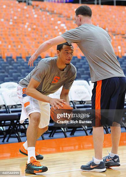 Tyler Ennis and assistant coach Gerry McNamara of the Syracuse Orange warm up prior to the game against the Miami Hurricanes at the Carrier Dome on...