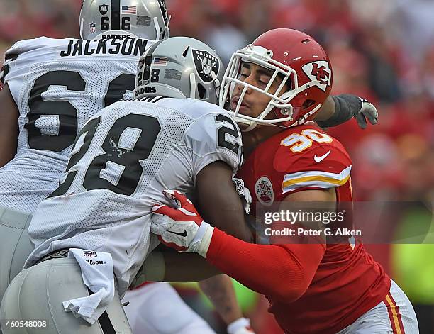 Linebacker Josh Mauga of the Kansas City Chiefs tackles running back Latavius Murray of the Oakland Raiders during the first half on December 14,...