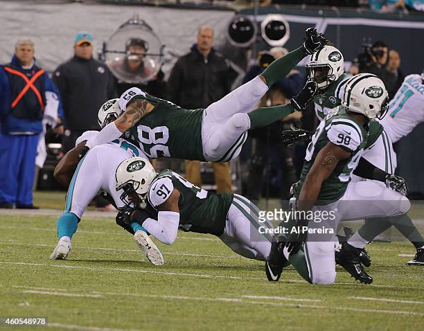 Linebacker Calvin Pace and Linebacker Jason Babin of the New York Jets make a stop against the Miami Dolphins at MetLife Stadium on December 1, 2014...