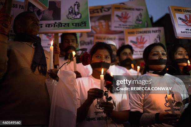 Indian political and civil society activists take part in a vigil to mark the second anniversary of the fatal gang-rape of a student in the Indian...