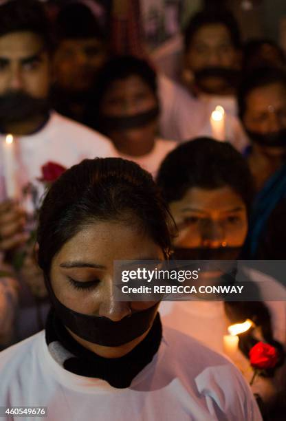 Indian political and civil society activists take part in a vigil to mark the second anniversary of the fatal gang-rape of a student in the Indian...