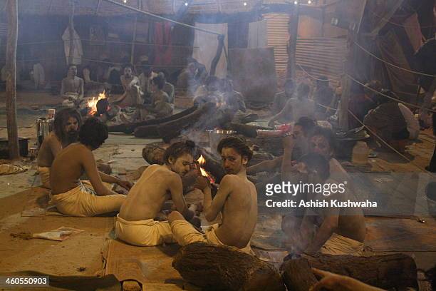 Sadhus" smoking 'Chillum' inside their tents, at Kumbha Mela 2013, Allahabad