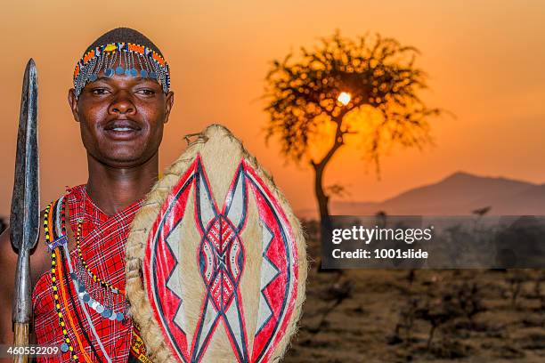 african young masai warrior at sunset - masai-mara-national-reserve stockfoto's en -beelden