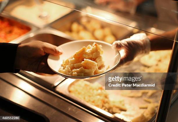 Student takes a plate during lunch time at a secondary school on December 1, 2014 in London, England. Education funding is expected to be an issue in...
