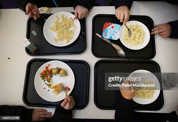 Students eat their lunch in the canteen at a secondary school on December 1, 2014 in London, England. Education funding is expected to be an issue in...