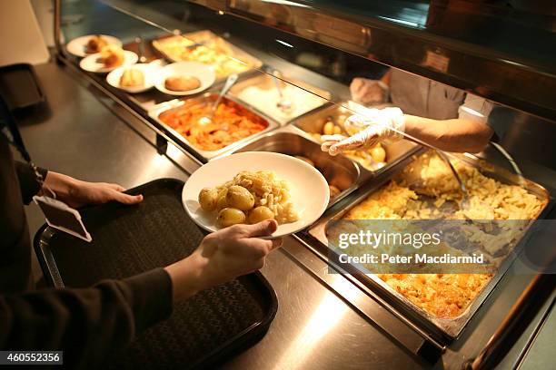 Student takes a plate during lunch time at a secondary school on December 1, 2014 in London, England. Education funding is expected to be an issue in...