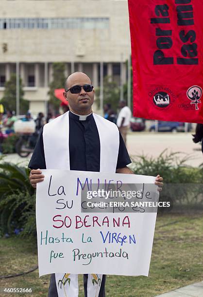 An alleged priest holds a sign during a pro-abortion demonstration in front of the National Congress in Santo Domingo, Dominican Republic, on...