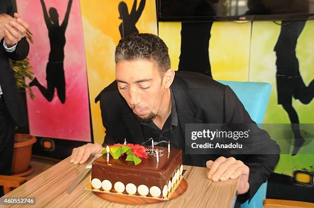 The worlds tallest man Sultan Kosen who holds the Guinness World Record for tallest living male at 2.51 m , blows out the candles during his 32nd...