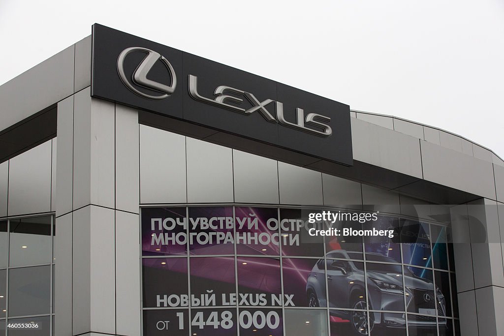 A Lexus sign stands on display outside a Lexus automobile d