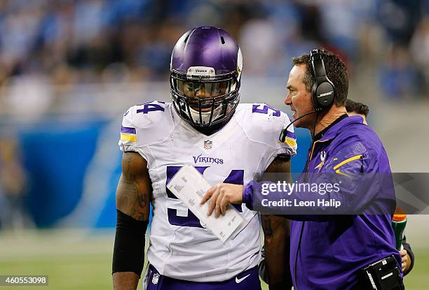 Minnesota Vikings head football coach Mike Zimmer talks with Jasper Brinkley during the second quarter of the game against the Detroit Lions at Ford...