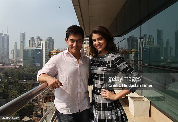 Bollywood actor Aamir Khan and Anushka Sharma pose for a picture during a visit to HT office for the promotion of their upcoming film PK on December...