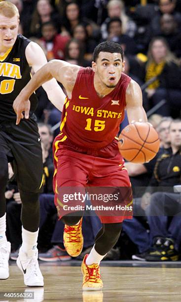 Guard Naz Long of the Iowa State Cyclones brings the ball downt he court in front of forward Aaron White of the Iowa Hawkeyes, in the second half on...
