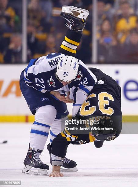 Zdeno Chara of the Boston Bruins fights Chris Thorburn of the Winnipeg Jets in the first period during the game at TD Garden on January 4, 2014 in...