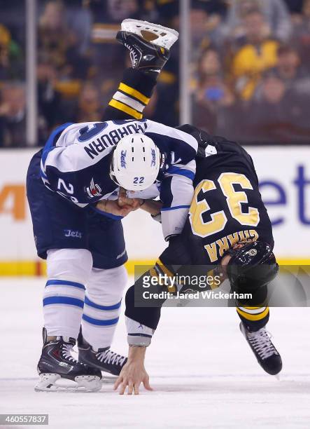 Zdeno Chara of the Boston Bruins fights Chris Thorburn of the Winnipeg Jets in the first period during the game at TD Garden on January 4, 2014 in...