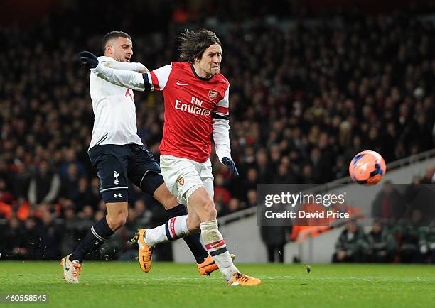 Tomas Rosicky scores Arsenal's 2nd under pressure from Kyle Walker of Tottenham during the FA Cup 3rd Round match between Arsenal and Tottenham...