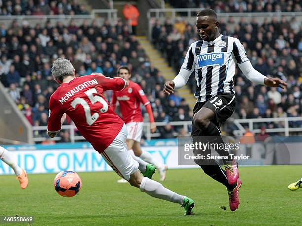 Mapou Yanga-Mbiwa of Newcastle is challenged by Cardiff City's Kevin McNaughton during the Budweiser FA Cup third round match between Newcastle...