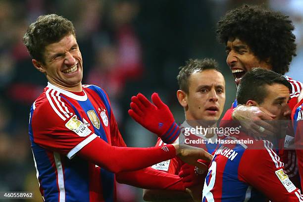 Thomas Mueller of Muenchen celebrates scoring the 2nd team goal with his team mate Dante and others during the Bundesliga match between FC Bayern...