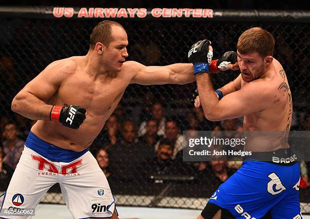 Junior Dos Santos of Brazil punches Stipe Miocic in their heavyweight fight during the UFC Fight Night event at the U.S. Airways Center on December...