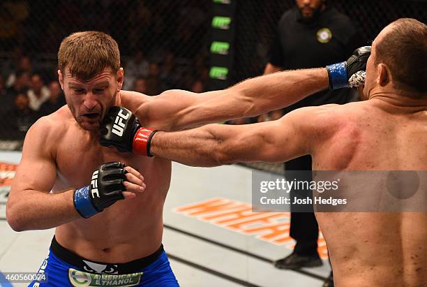 Junior Dos Santos of Brazil and Stipe Miocic trade punches in their heavyweight fight during the UFC Fight Night event at the U.S. Airways Center on...