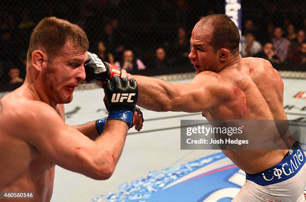 Junior Dos Santos of Brazil punches Stipe Miocic in their heavyweight fight during the UFC Fight Night event at the U.S. Airways Center on December...