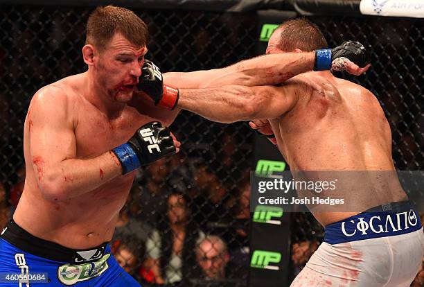 Junior Dos Santos of Brazil punches Stipe Miocic in their heavyweight fight during the UFC Fight Night event at the U.S. Airways Center on December...