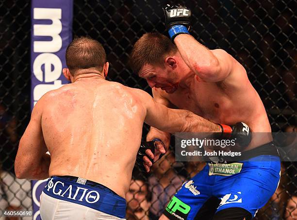 Junior Dos Santos of Brazil punches Stipe Miocic in their heavyweight fight during the UFC Fight Night event at the U.S. Airways Center on December...