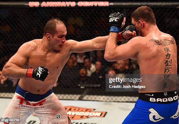 Junior Dos Santos of Brazil punches Stipe Miocic in their heavyweight fight during the UFC Fight Night event at the U.S. Airways Center on December...