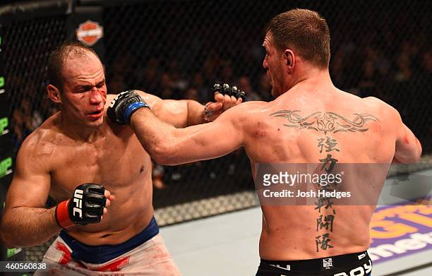 Junior Dos Santos of Brazil and Stipe Miocic trade punches in their heavyweight fight during the UFC Fight Night event at the U.S. Airways Center on...