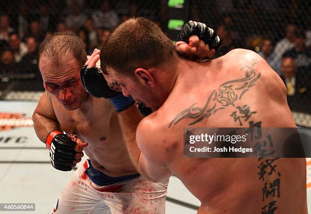 Junior Dos Santos of Brazil punches Stipe Miocic in their heavyweight fight during the UFC Fight Night event at the U.S. Airways Center on December...