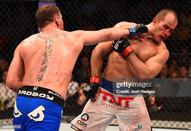 Stipe Miocic punches Junior Dos Santos of Brazil in their heavyweight fight during the UFC Fight Night event at the U.S. Airways Center on December...