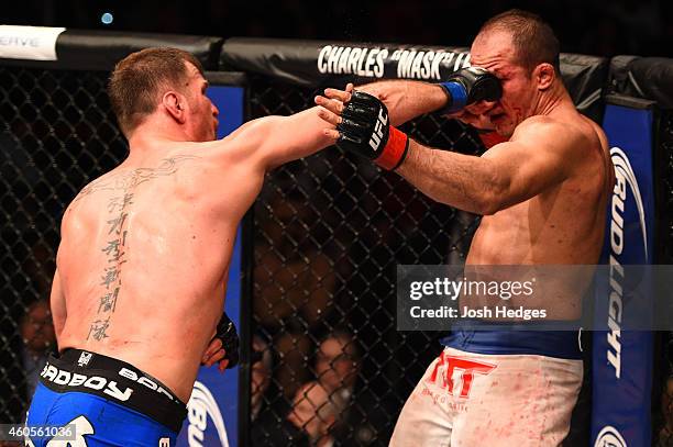 Stipe Miocic punches Junior Dos Santos of Brazil in their heavyweight fight during the UFC Fight Night event at the U.S. Airways Center on December...