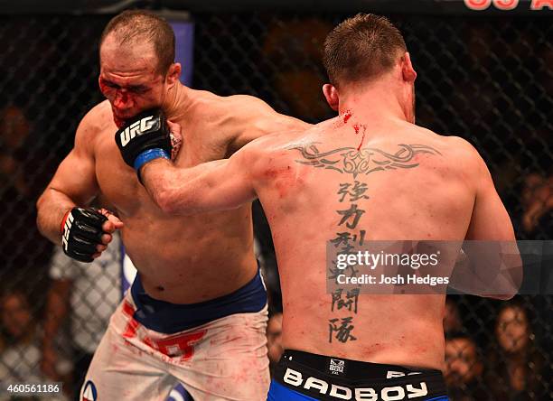 Junior Dos Santos of Brazil and Stipe Miocic trade punches in their heavyweight fight during the UFC Fight Night event at the U.S. Airways Center on...