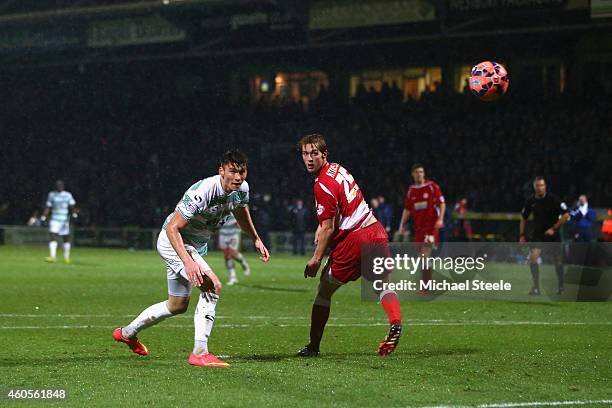 Kieffer Moore of Yeovil scores his sides second goal as Rob Atkinson of Accrington looks on during the FA Cup Second Round Replay match between...