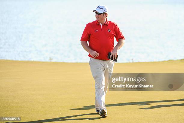 Brad Fritsch of Canada smiles after his seven-stroke victory on the 18th hole green of the Champion Course during the sixth and final round of the...