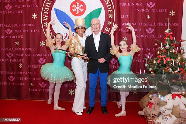 Moderator Arabella Kiesbauer and special guest Franz Beckenbauer pose with two children at the Energy For Life Christmas Ball For Children at Hofburg...