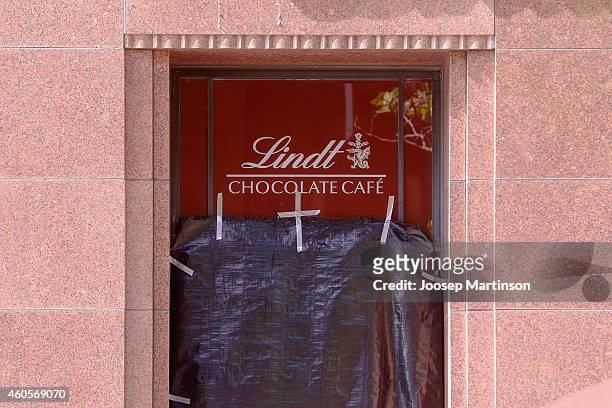 Window of Lindt Cafe in Martin Place is covered with plastic on December 17, 2014 in Sydney, Australia. Sydney siege gunman Man Haron Monis, was shot...