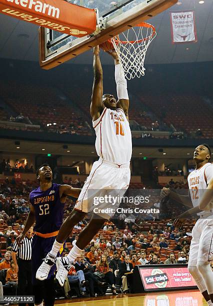 Jonathan Holmes of the Texas Longhorns slam dunks against the Lipscomb Bisons at the Frank Erwin Center on December 16, 2014 in Austin, Texas.