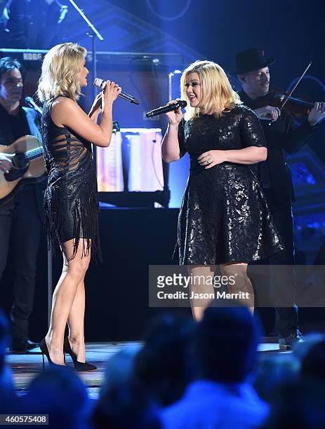 Miranda Lambert and Kelly Clarkson perform at the the 2014 American Country Countdown Awards at Music City Center on December 15, 2014 in Nashville,...