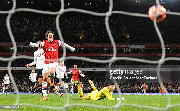 Tomas Rosicky chips the ball over Tottenham goalkeeper Hugo Lloris to score the 2nd Arsenal goal during the Budweiser FA Cup third round match...