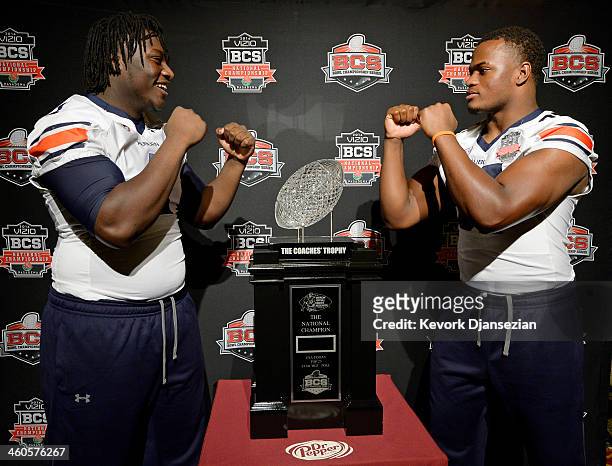 Montravius Adams and Elijah Daniel of the Auburn Tigers pose with The Coches Trophy during the Vizio BCS National Championship media day January 4,...