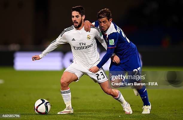 Isco of Real Madrid is challenged by Hernan Bernardello of Cruz Azul during the FIFA Club World Cup Semi Final match between Cruz Azul and Real...