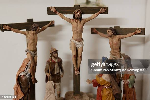 An scene of Jesus Christ crucified clay figurines stands on a shelf at Jose Luis Mayo's workshop on December 16, 2014 in Madrid, Spain. Jose Luis...