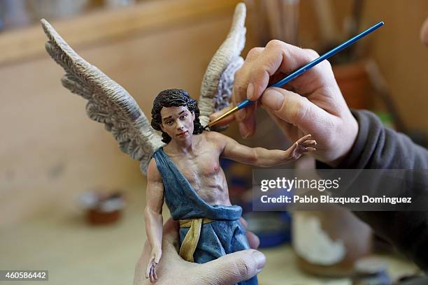 Mercedes Munoz paints an Angel clay figurine at Jose Luis Mayo's workshop on December 16, 2014 in Madrid, Spain. Jose Luis Mayo is a recognized...