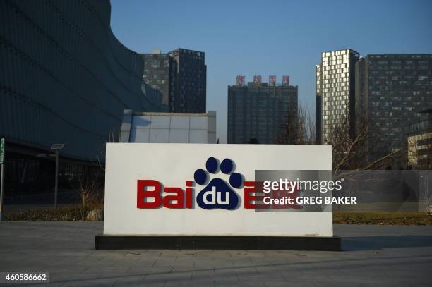 The Baidu logo is seen outside the Baidu headquarters in Beijing on December 17, 2014. Baidu, China's leading search engine, and ride sharing company...