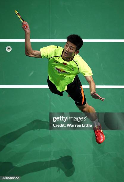 Chen Long of China plays a smash against Kenichi Tago of Japan during the Men's Singles match on day one of the BWF Destination Dubai World...